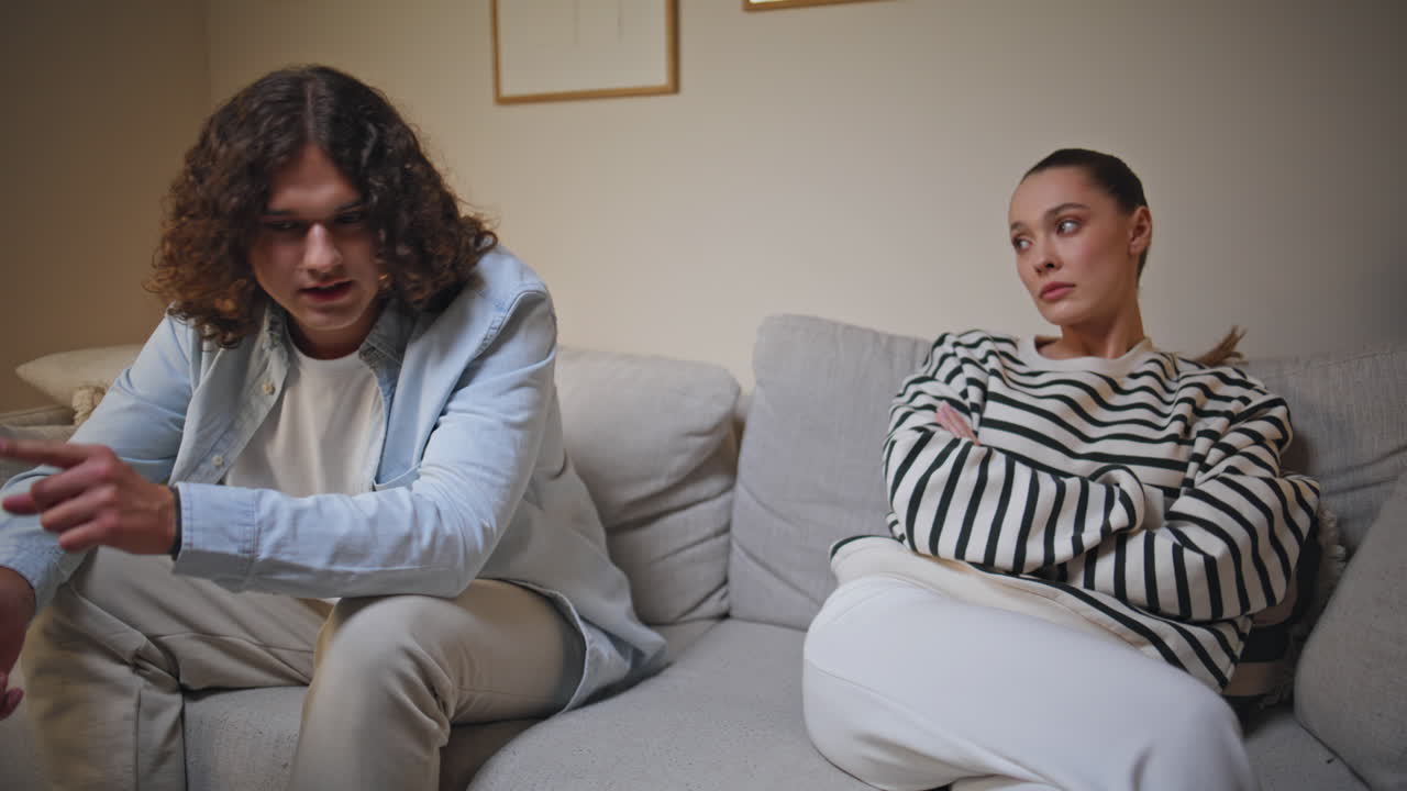 Worried couple discussing relationship problem in living room sofa closeup