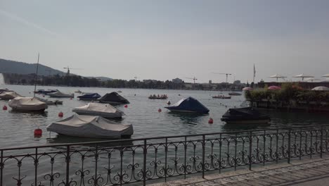 Zurich,-Switzerland---June-16,-2019:-boats-on-Lake-Zurich-at-sunset,-buildings-of-the-city-of-Zurich