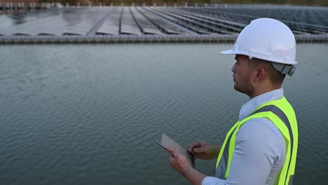 asian engineer working at floating solar farm