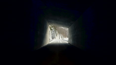pov of a driver driving on tunnel road revealing snowy mountain near eresfjord in norway.