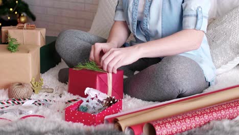 girl's hands wrapping the christmas presents