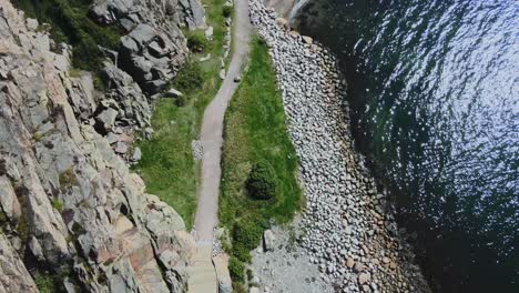 flying over the wooden walkway towards långevik beach in sweden -aerial