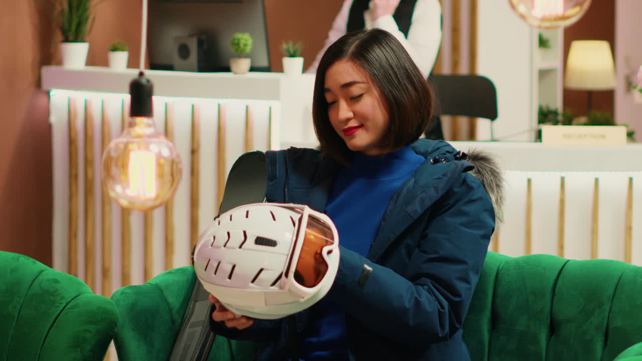 mujer asiática preparándose para la sesión de esquí