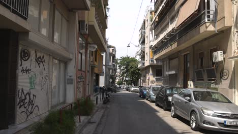 cars and pedestrians navigate a narrow street