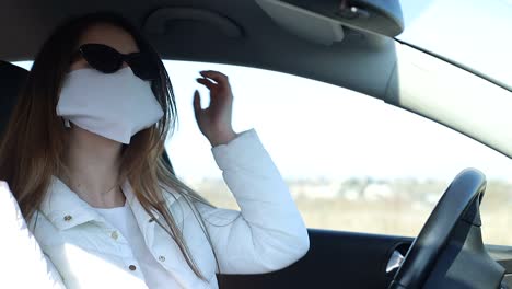 sick girl wearing protection during pandemic. pretty young caucasian girl taking on medical mask outdoor. girl wearing medical mask during coronavirus covid-19 epidemic