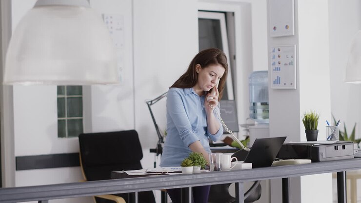 Woman in Office on Phone Call