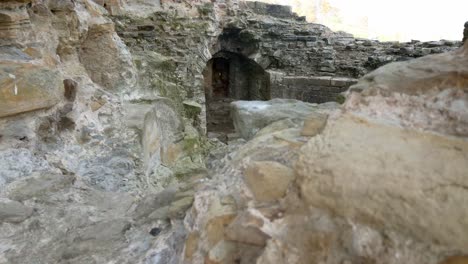 Ancient-Basingwerk-abbey-abandoned-historical-landmark-building-stone-walls-left-close-up-dolly