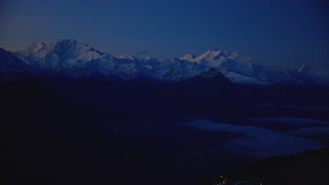 panoramic view of mountain range in swiss alps at twilight, blue hour view of monte rosa massif and matterhorn mountain in horizon after sunrise