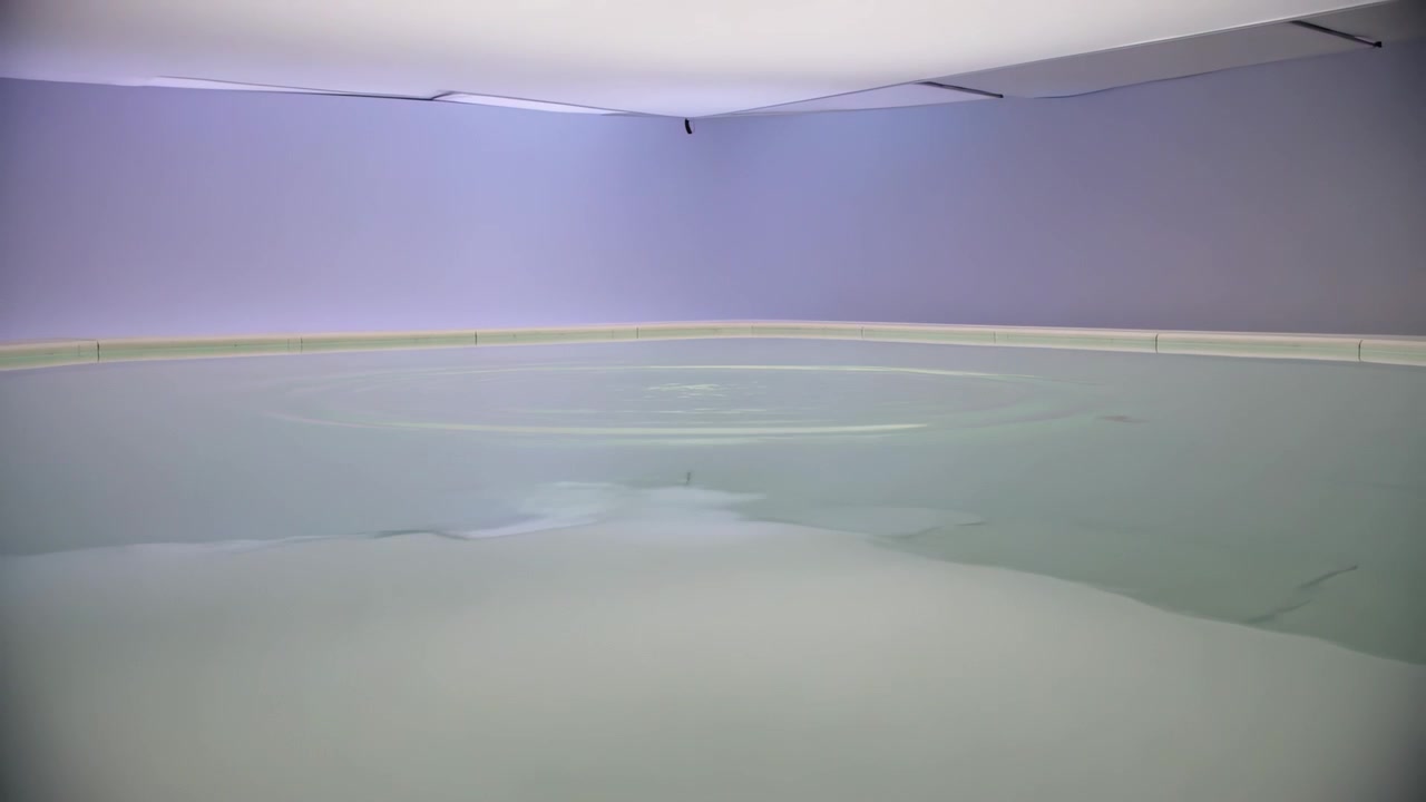 Showing shallow water basin making circular ripples in small room corner, triggered by drop