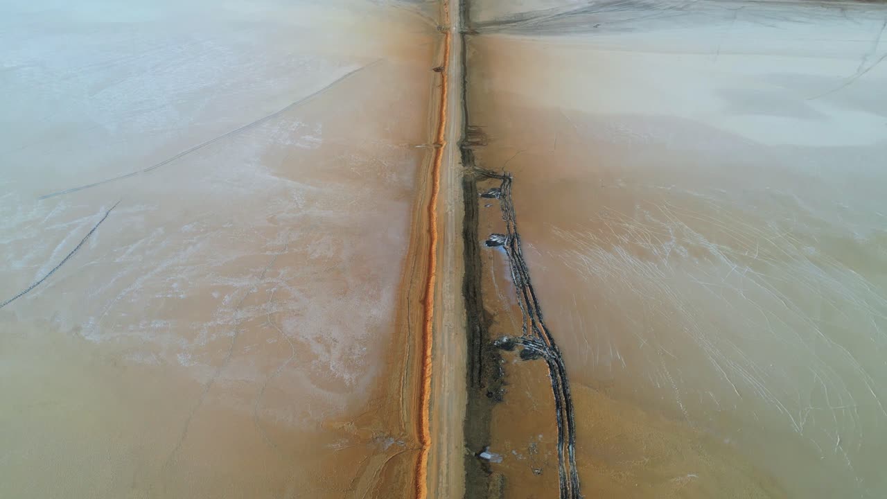A stunning closeup drone view of the Rann of Kutch, Gujarat, showcasing endless white salt desert under a clear blue sky. The vast, shimmering landscape stretches infinitely, serene and surreal 4K