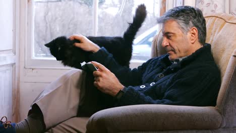 Man-reading-book-in-living-room-at-home