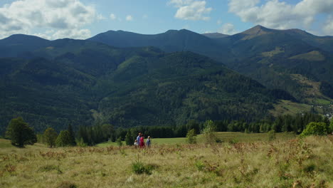 children parents against hills walking together admiring beautiful landscape