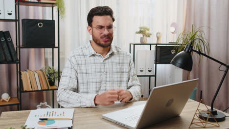 indian businessman freelance using laptop bad news lottery results fortune loss fails at home office