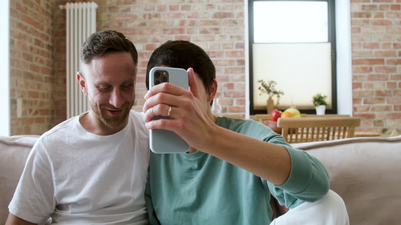 Couple doing videocall on the sofa