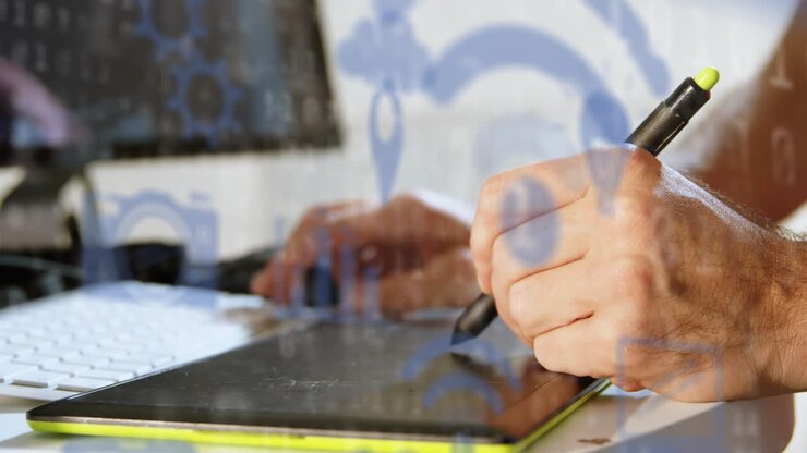 Animation of technology icons over hands of caucasian man using graphic tablet