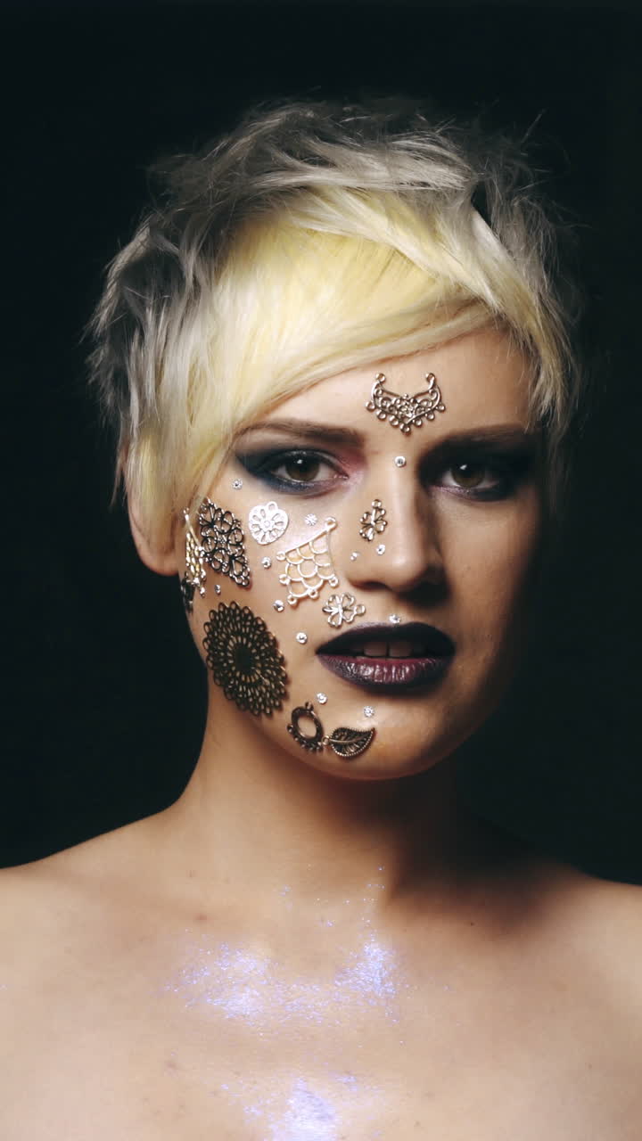 Glam woman with glittering make-up. Portrait of gorgeous glam caucasion woman, artistic glittering make-up and naked shoulders