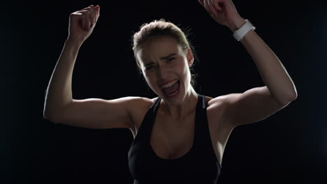 Excited-woman-winner-celebrating-victory-with-raised-hands-in-slow-motion