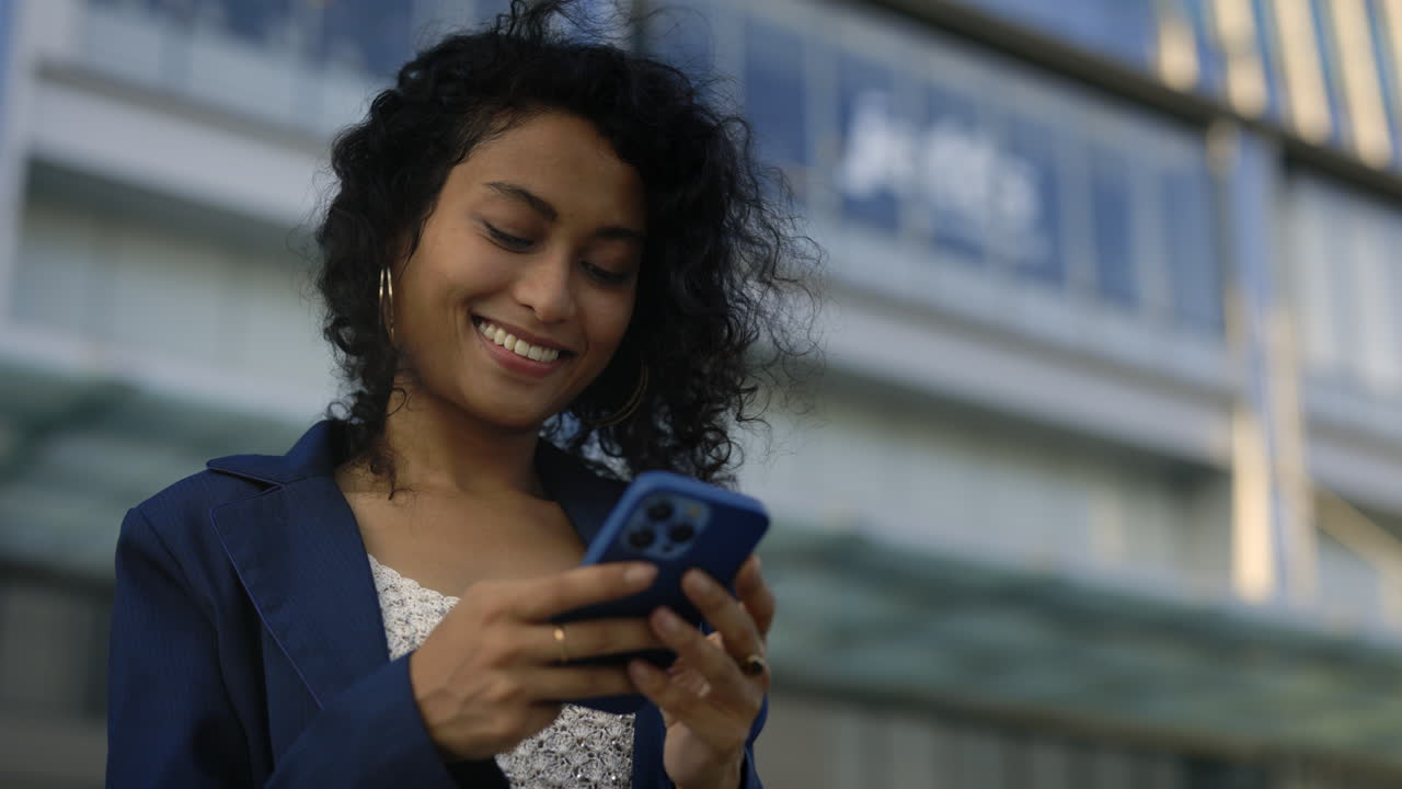 Businesswoman using smartphone in city