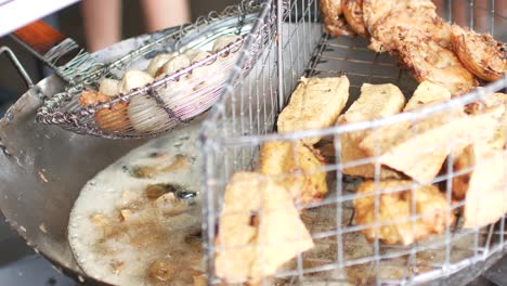 POV-to-the-pan-full-of-fried-spring-roll,fried-tofu,fried-fish-ball-fro-appetizer