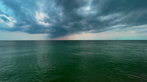 stormy sky and clouds over calm sea with