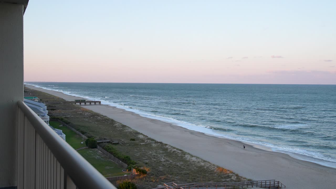 Wide shot from a balcony overlooking Carolina Beach, NC to the North at sunset