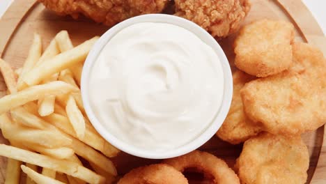 fried chicken, fries, onion rings, and nuggets with dip