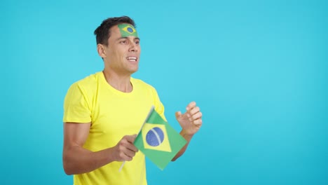 nervous brazilian supporter during an exciting match looking away