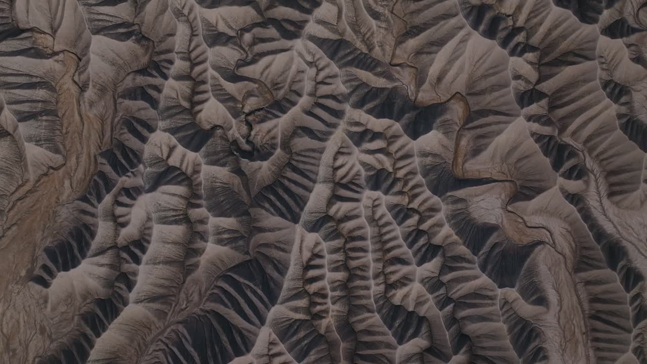 Eroded desert badlands ridges forming intricate terrain patterns near Factory Butte Utah, drone