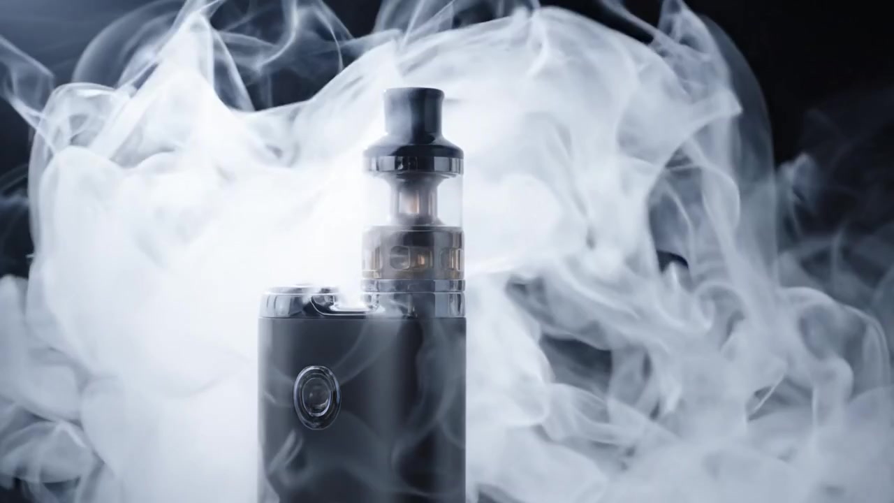 A Stylish Vape Device Captured in Two Dramatic Moments: One with Clean Lines Against a Dark Background, and Another Surrounded by Swirling Clouds of Vapor