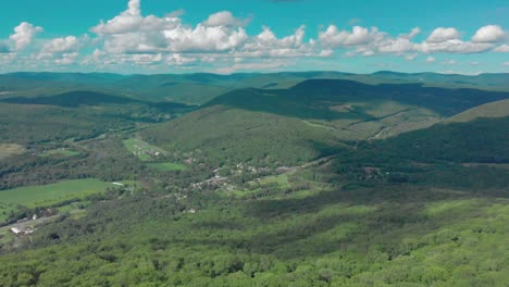 drone descent into beautiful valley with town below in the catskill mountains of new york state