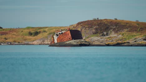 a rusty shipwreck on the rocky shore of the atlantic