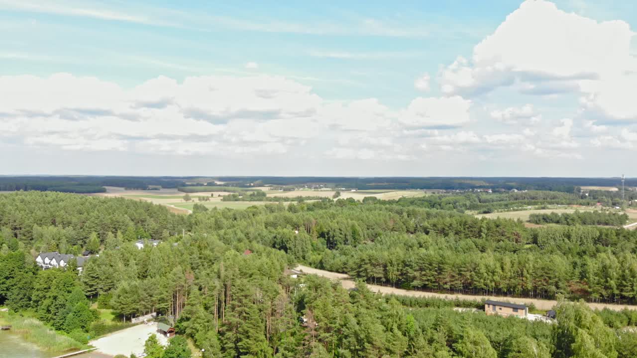 A drone captures a high-altitude view of the expansive Borowy Młyn forest in Poland's Pomeranian Voivodeship