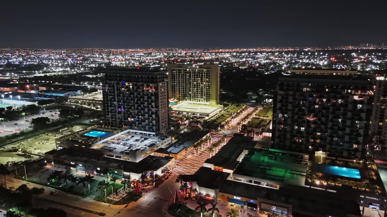 Aerial orbit city Skyline Doral in Florida at night, endless lights in the horizon