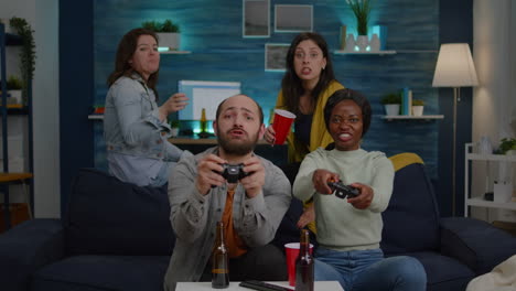 Woman-with-dark-skin-losing-videogames-against-friend-man-while-playing-for-gaming-competition