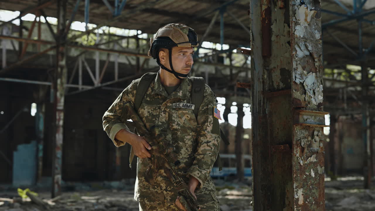 Soldier in Camouflage Uniform in a Ruined Factory