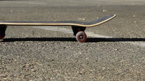 Skateboard-in-Parking-Lot-Rolls-By-Camera-Left-to-Right-Extreme-Sports