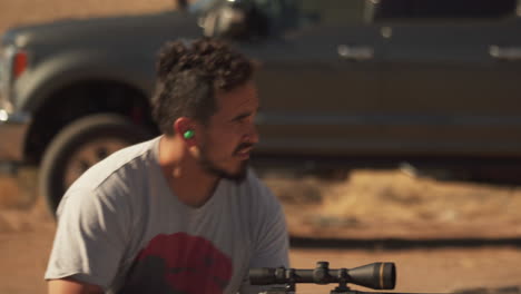 Hispanic-male-hunter-takes-aim-after-he-checks-and-adjusts-R25-Rifle