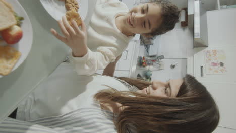 pov joyous mom and daughter web calling at breakfast