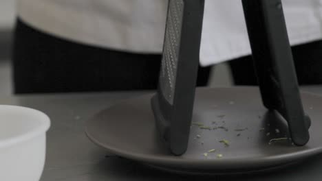 Peel-grate-fresh-lemon-on-kitchen-table-while-cooking-tasty-pie-during-the-day-close-up-detail-shot