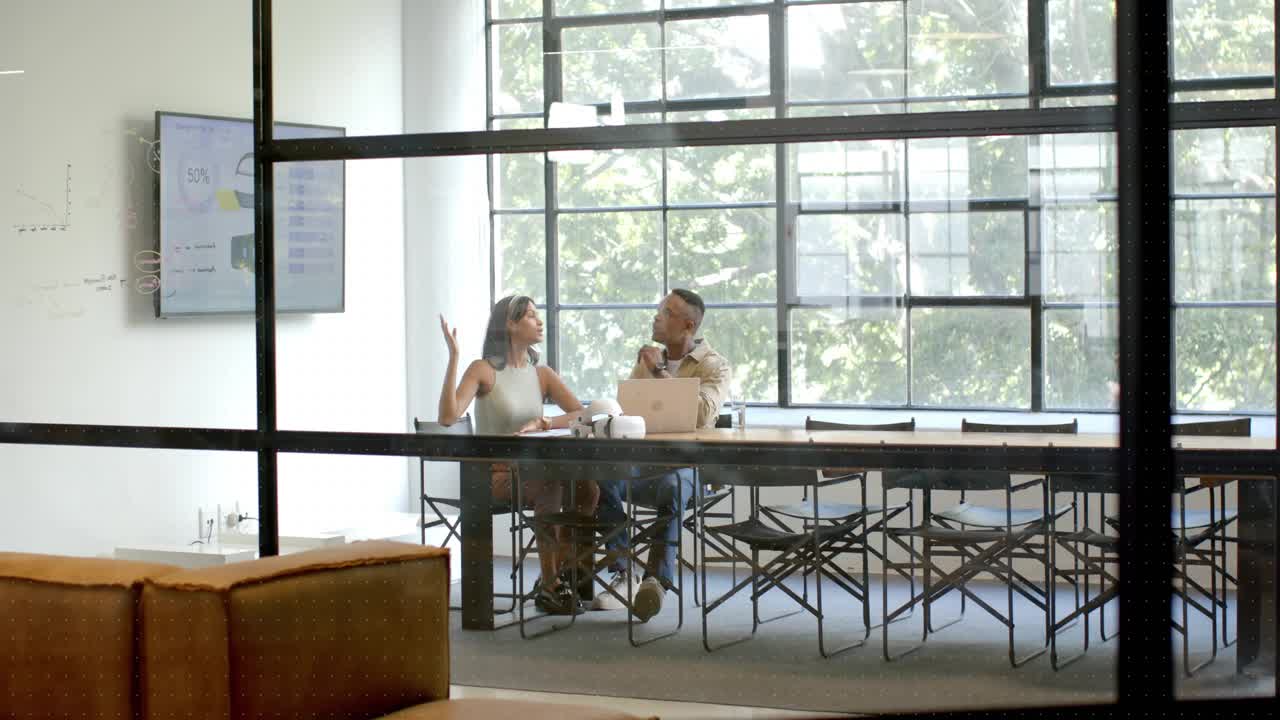 Colleagues sitting at glass table, HUD sweeping locking onto them, analyzing business chart