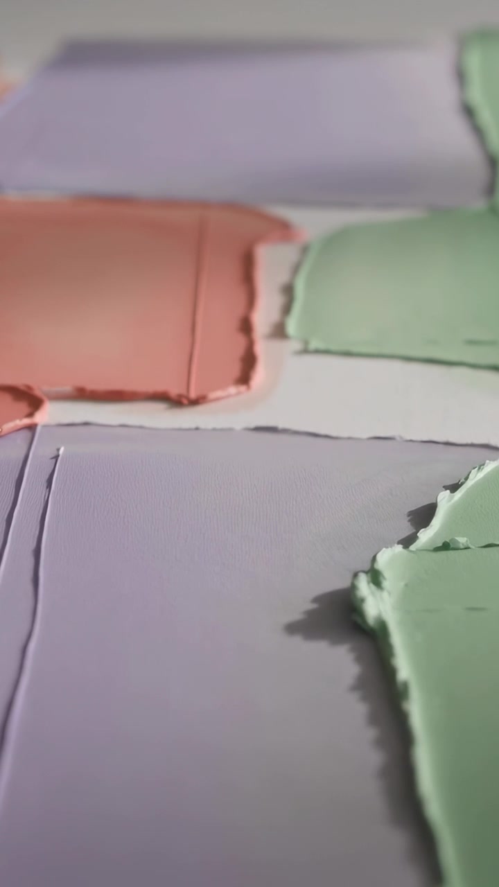 Vertical video: Smoothing hand appearing top-left, pressing pastel paints on panel, evening seams