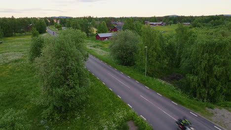 motorcycles driving on lapland road through green fields in northern sweden