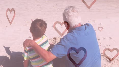 animation of hearts falling over caucasian man and his grandson at beach