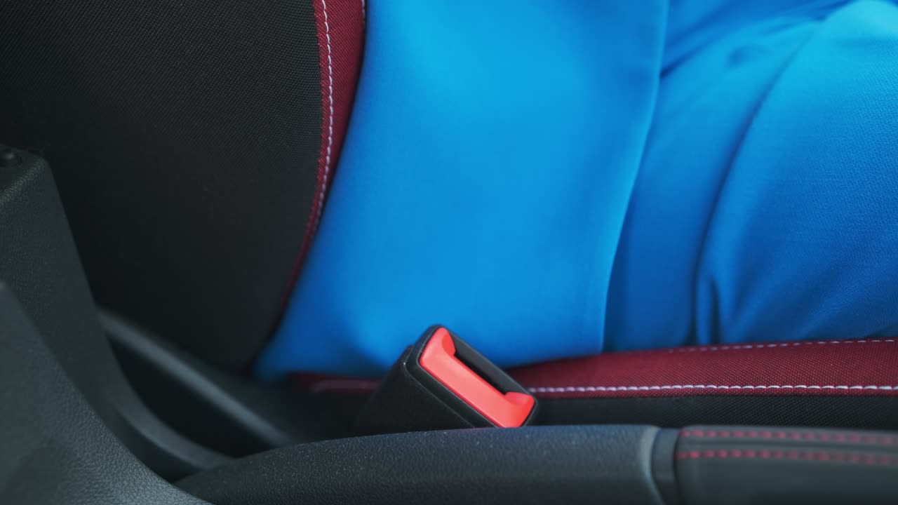Close up woman fastening her seat belt before driving