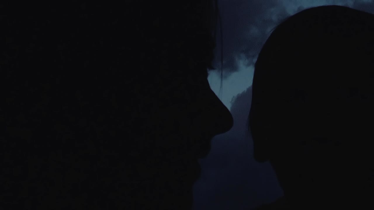 mamá está abrazando al bebé contra la puesta de sol