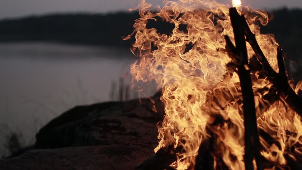 Big Night Bonfire On The Riverbank. Red hot flame of campfire in the evening