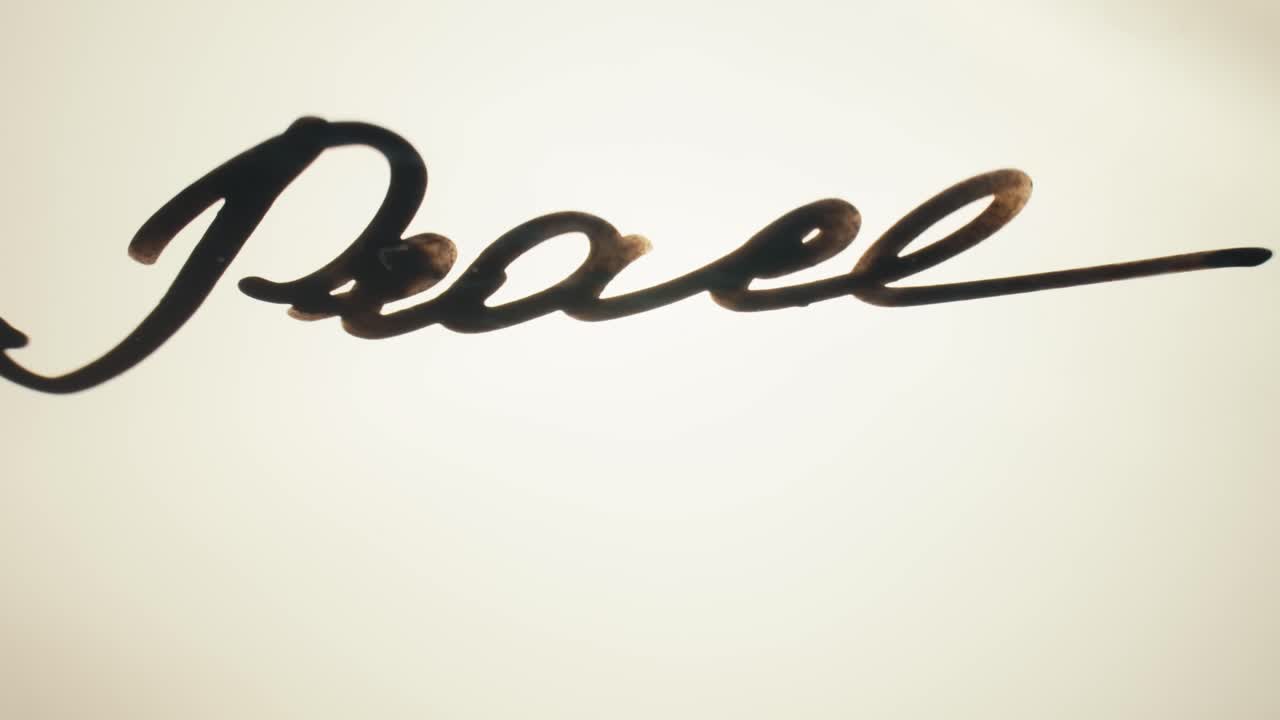 The Word Peace Written and Erased on a White Background