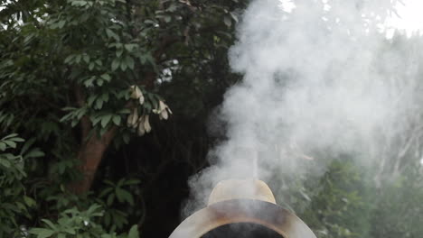 Smoke-billowing-out-of-outdoor-pizza-oven