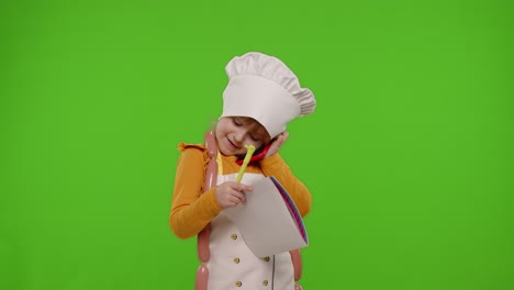 adorable little girl dressed as a chef