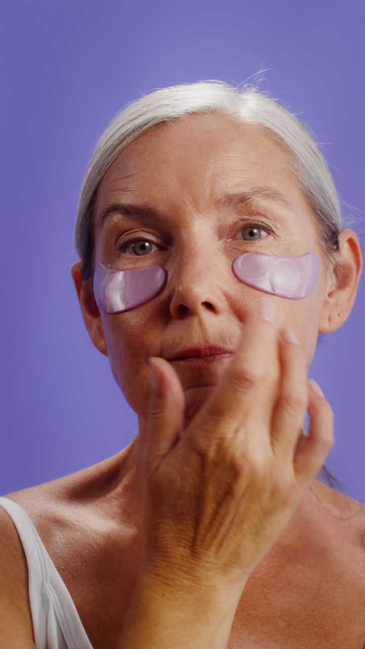 Mature Woman Applying Eye Patches for Skincare